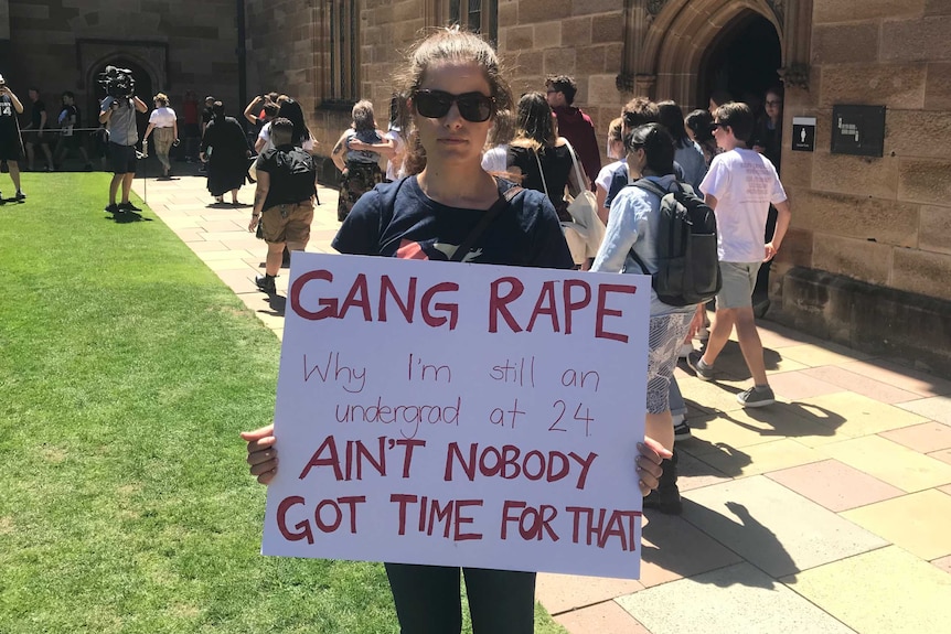 A student holds a sign at a protest rally at the University of Sydney