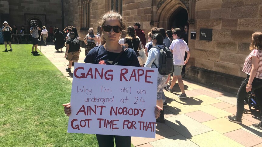 A student holds a sign at a protest rally at the University of Sydney