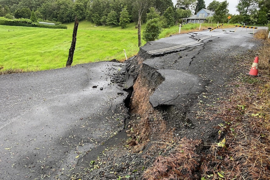 A road has broken in two, with one side much higher than the other