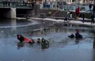 Skaters dragged from Amsterdam canal after falling through thin ice ...