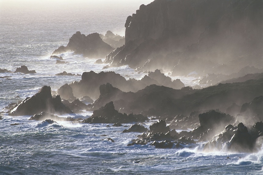 Rugged granite cliffs with waves bashing in from the west.