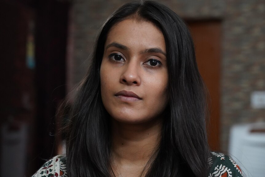 A close up shot of a young Indian woman with long dark hair. 