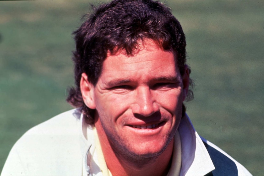 A Former Australian Test cricketer poses for a photograph in training gear.