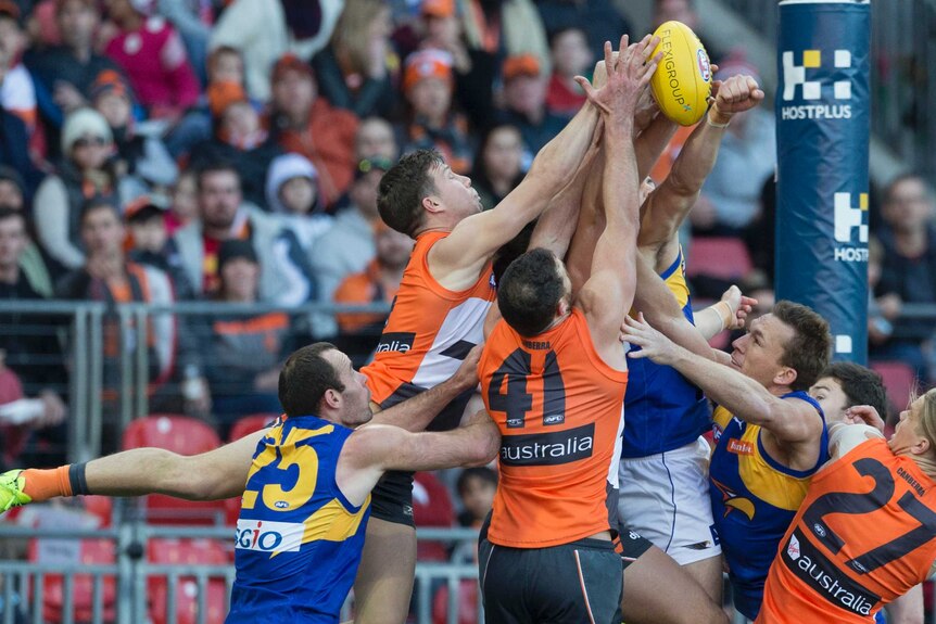 Toby Greene of the Giants and Shane Mumford of the Giants go up for a mark against West Coast.