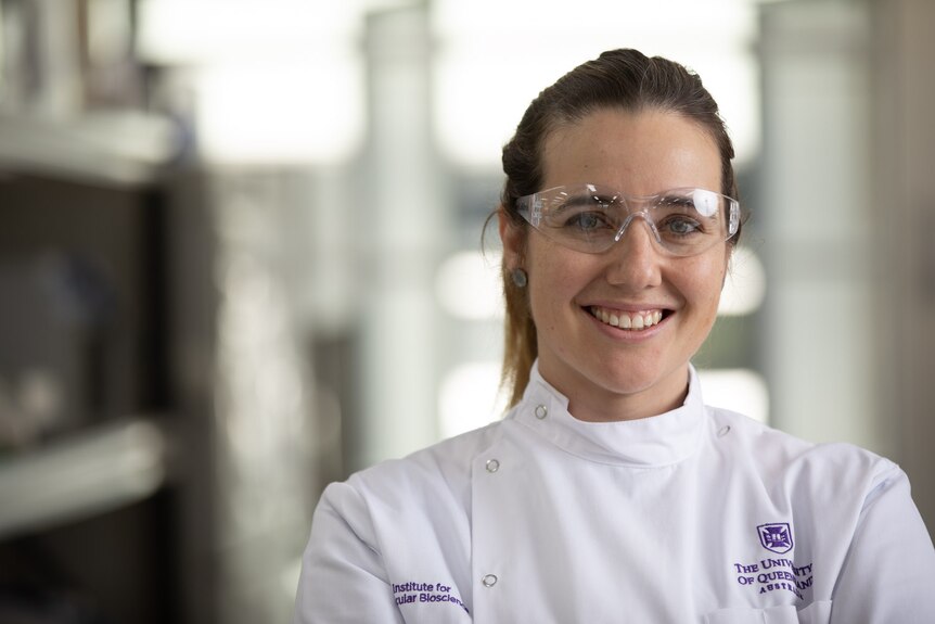 University of Queensland immunologist Dr Larisa Labzin, wearing goggles, smiles at the camera.