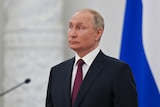 Vladimir Putin stands at an awarding ceremony in Moscow.