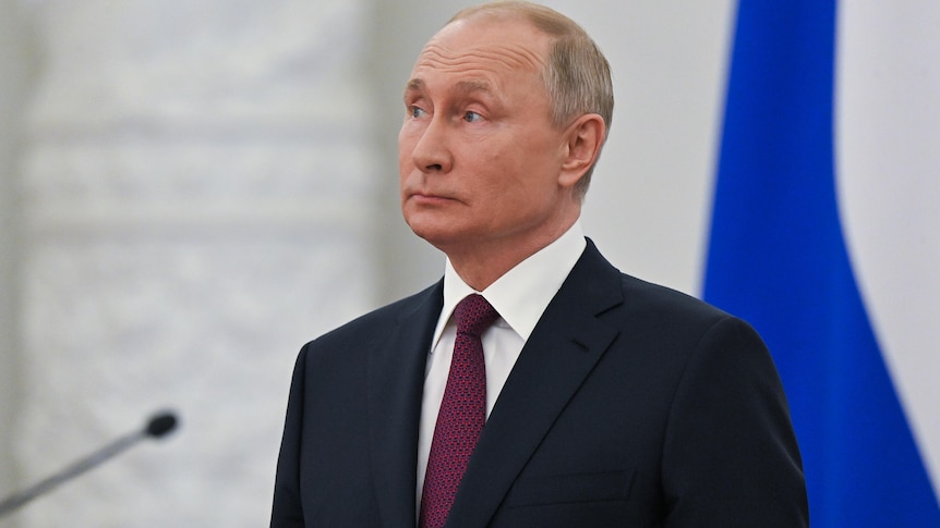 Vladimir Putin stands at an awarding ceremony in Moscow.