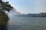 Fire seen in the distance across the water at Baffle Creek