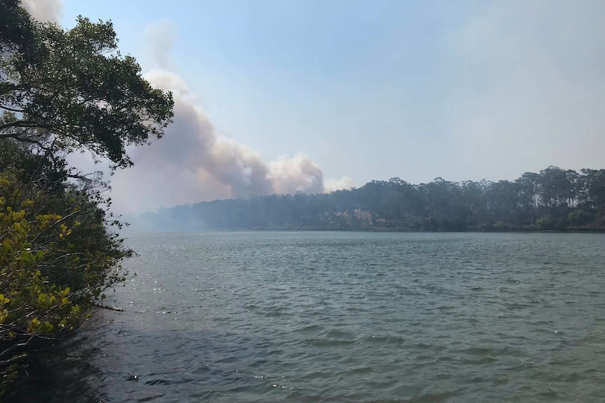 Fire seen in the distance across the water at Baffle Creek