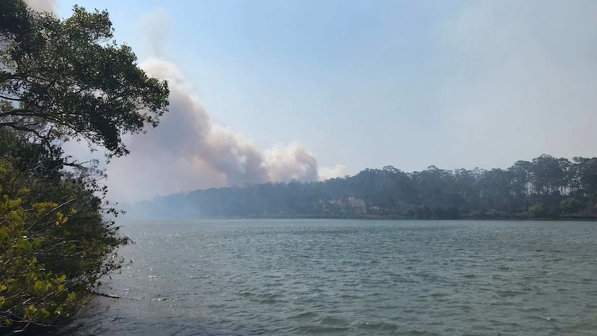 Fire seen in the distance across the water at Baffle Creek