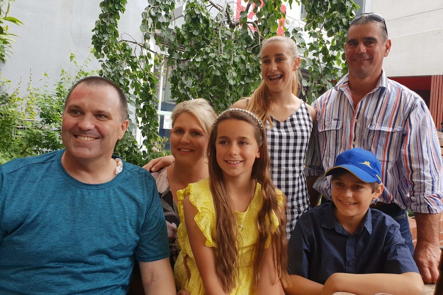 Tasmania Police Inspector Darren Hopkins with the Kilby family