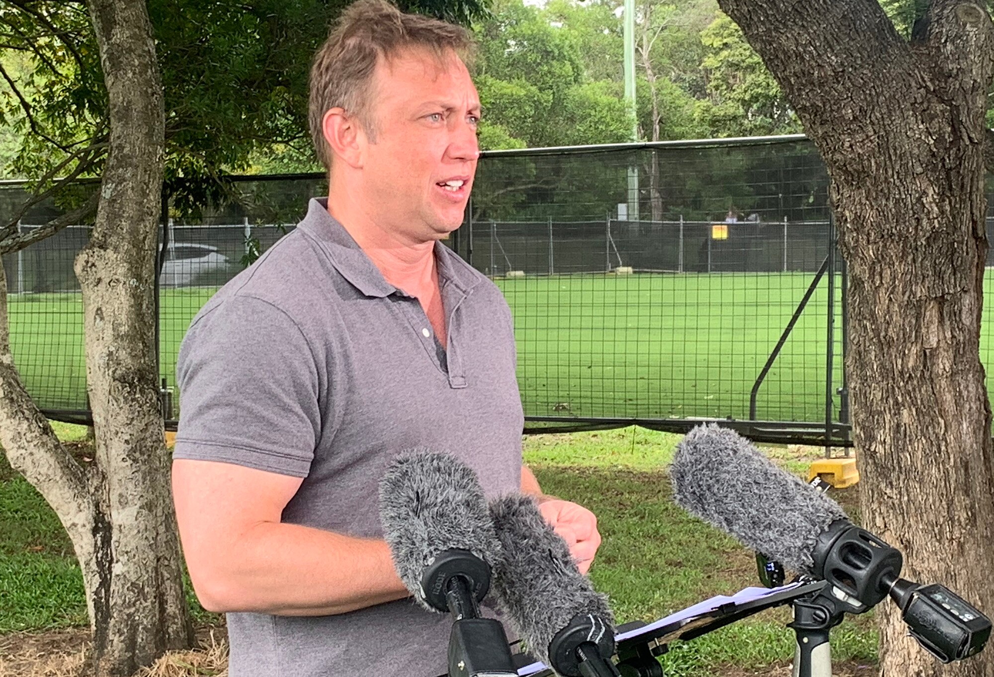 Premier Steven Miles standing in front of microphones and speaking to reporters