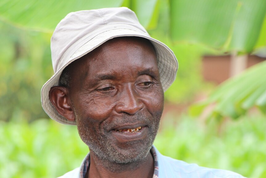 A coffee grower standing in a coffee plantation