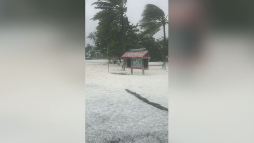 Thick sea foam rolls onto Sarina Beach during Cyclone Debbie