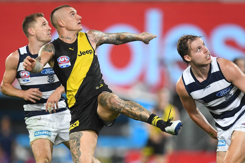 Dustin Martin kicks a goal under pressure for Richmond against Geelong during the AFL grand final at the Gabba