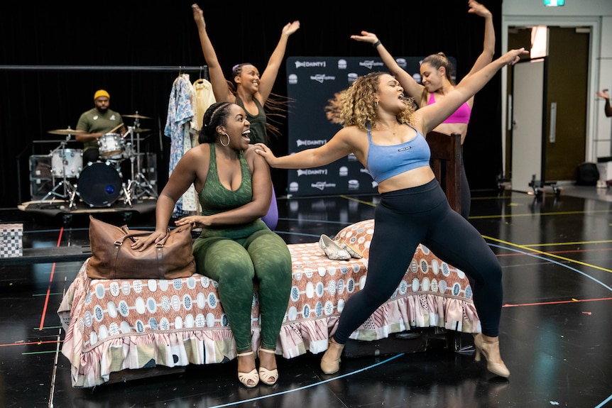 Ngwenya and Jayme Lee Hanekom, two Black women wearing exercise clothes, perform a scene in rehearsals. 