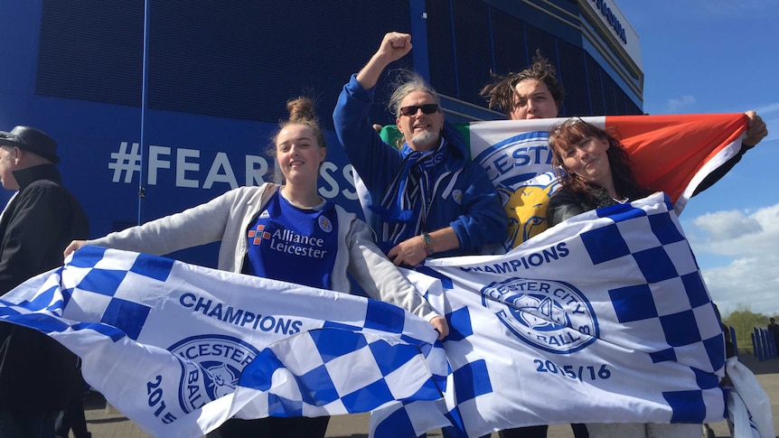 Leicester City fans celebrate the Foxes' Premier League title win outside the club's stadium.