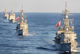 Military ships with the US dan Japan flags in the ocean