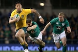 Folau makes a break for the Wallabies against Ireland