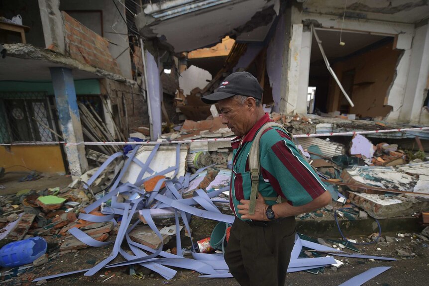 Man stands in rubble