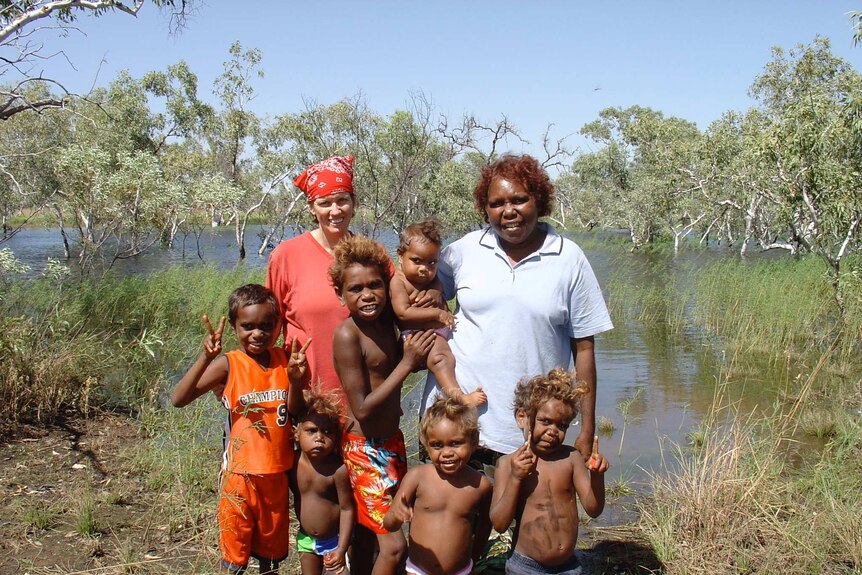 A portrait of Carmel O'Shannessy with Gracie White Napaljarri and her family in Lajamanu