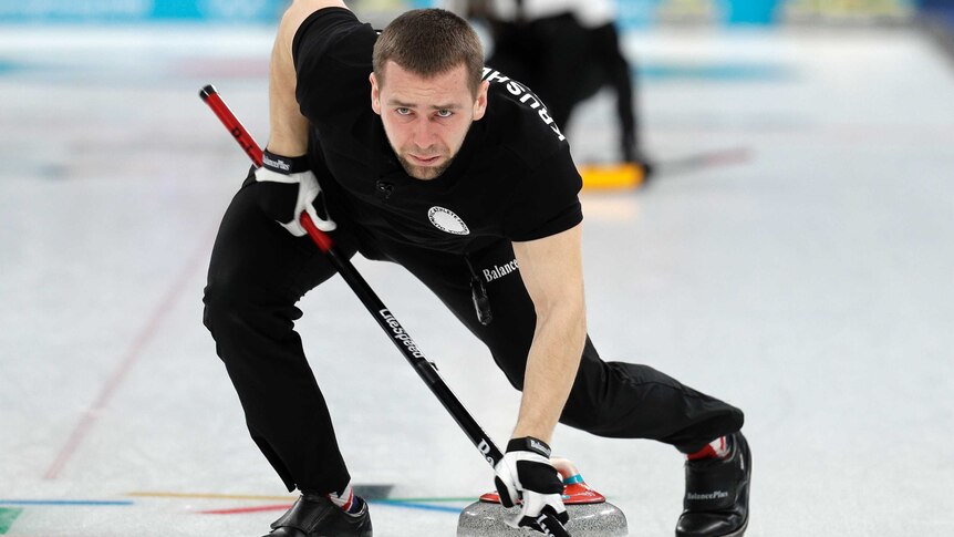 Russia's Alexander Krushelnitsky sweeps ice during mixed doubles curling match against Norway.