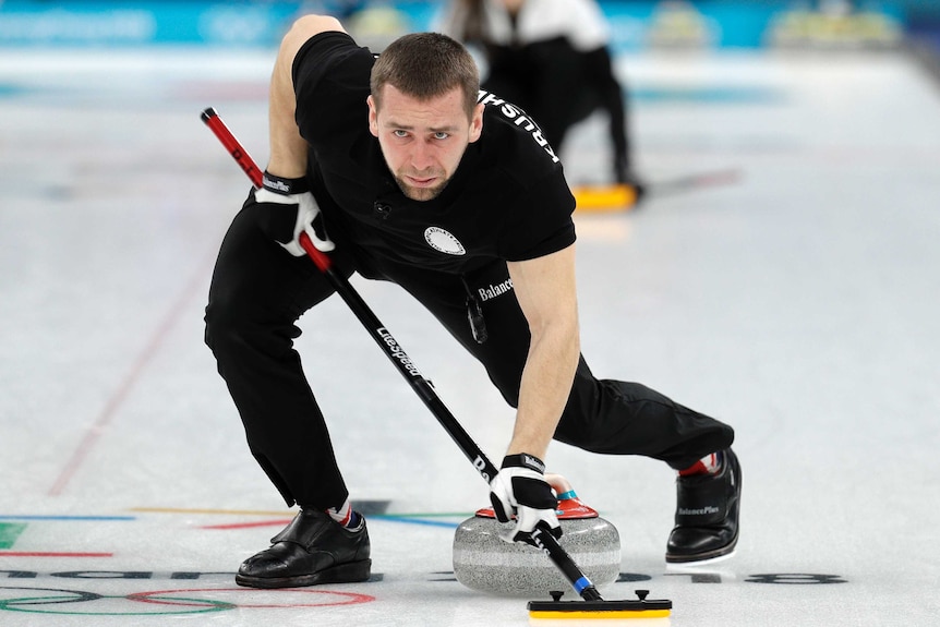 Olympic Athlete from Russia Alexander Krushelnitsky sweeps the ice during the mixed doubles curling at Pyeongchang.