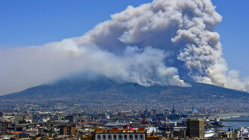 Smoke rises from wild fires burning on the slopes of Mount Vesuvius volcano as seen from Naples.