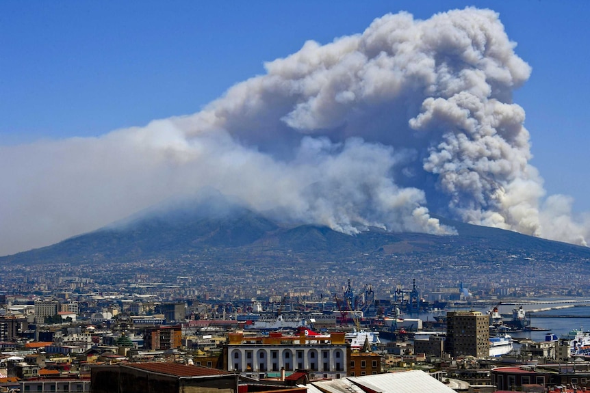 Smoke rises from wild fires burning on the slopes of Mount Vesuvius volcano as seen from Naples.
