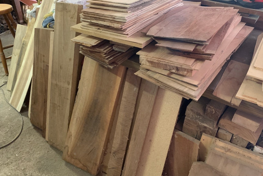 Slats of timber stacked on a workbench.