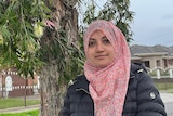 a woman in a hijab on a suburban street
