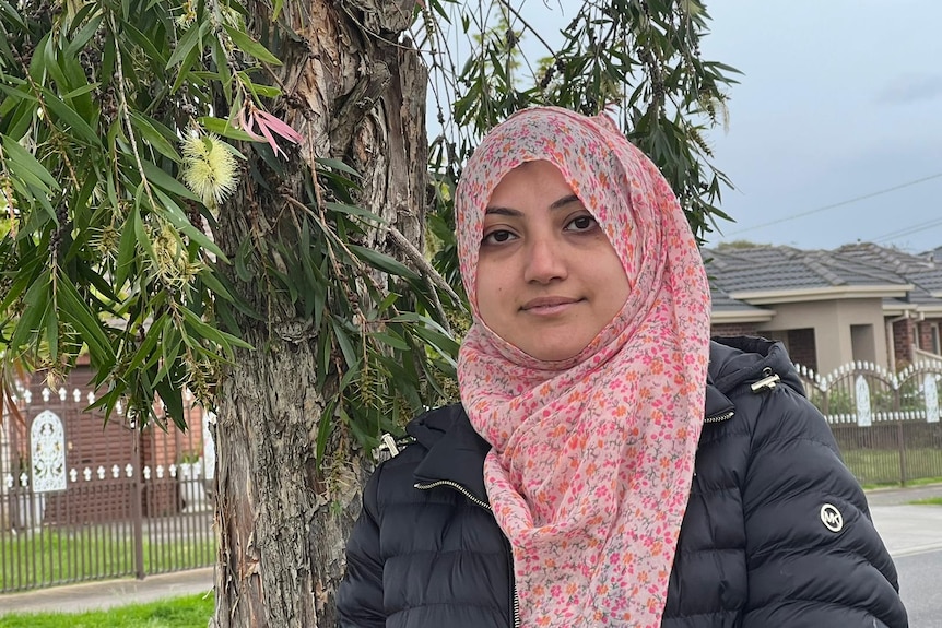 a woman in a hijab on a suburban street
