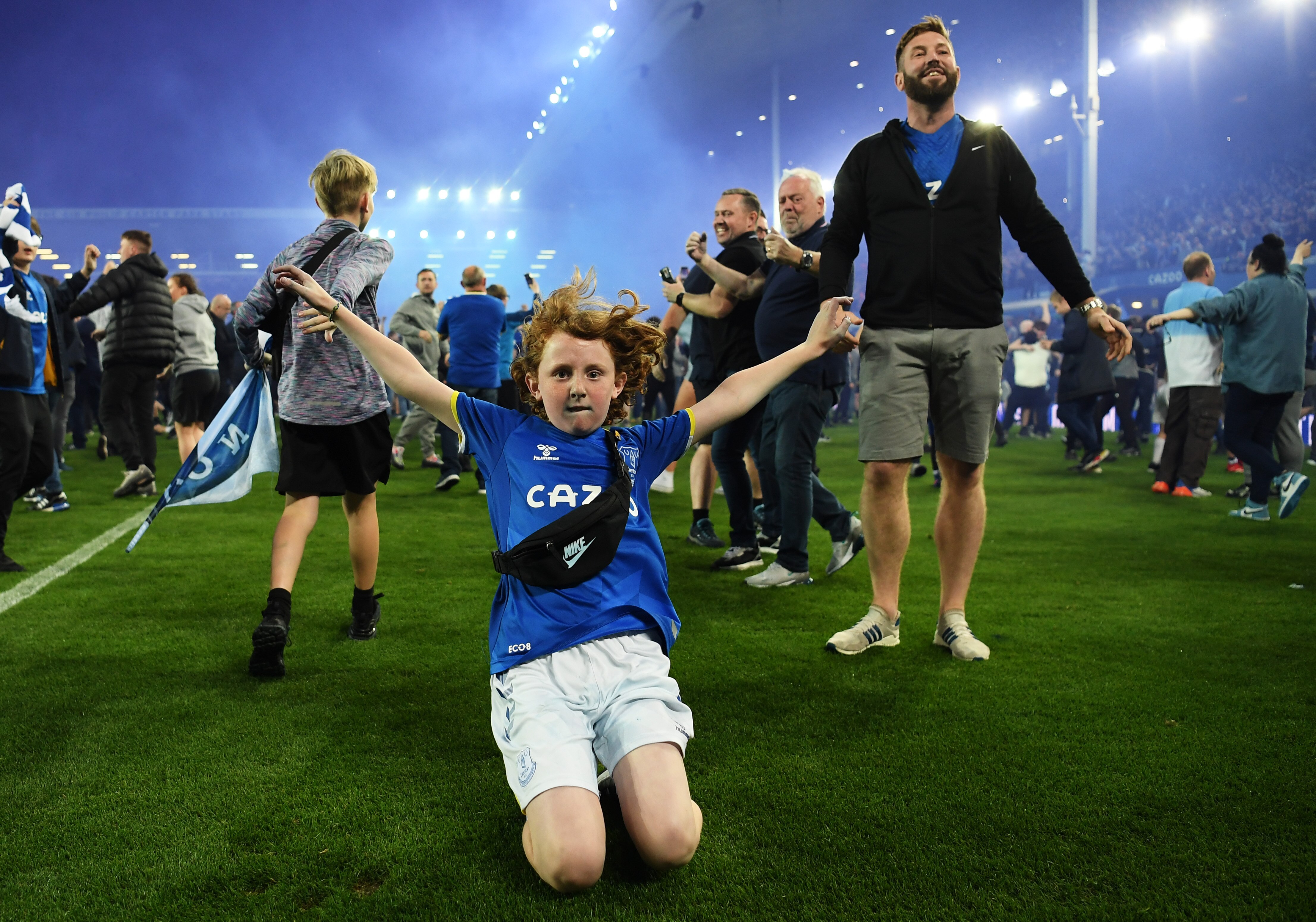 Fans flood the pitch as Everton escape Premier League relegation with