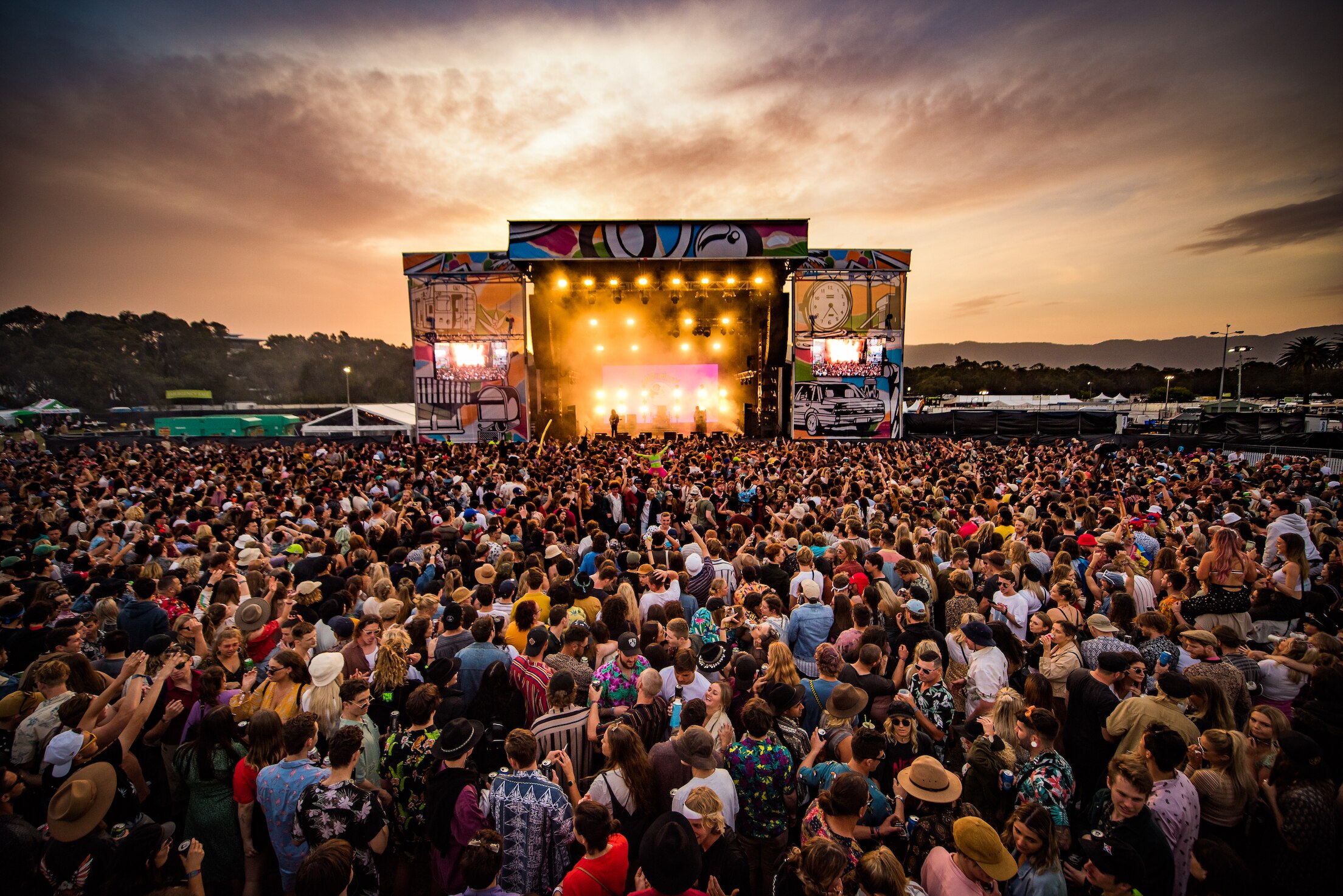 A semi aerial crowd photo from Yours and Owls festival at sunset facing one of the stages.