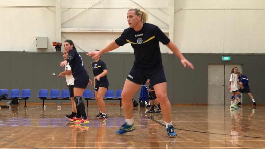 Hannah Mouncey playing handball on a court in Geelong.