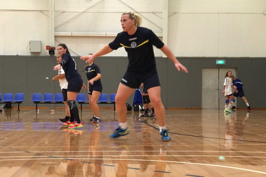 Hannah Mouncey playing handball on a court in Geelong.