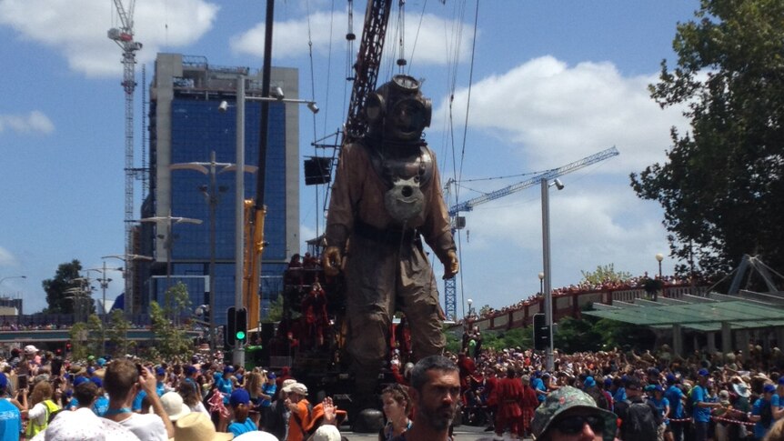 Giant diver marionette moves through the streets of Perth