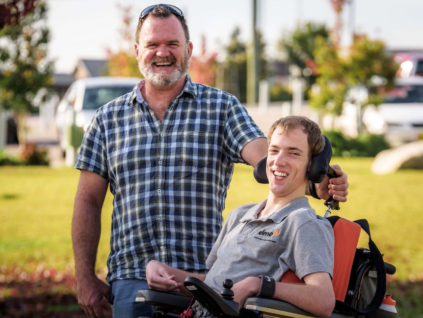 Disability support worker. Man with a Disability newspaper. Brogo.