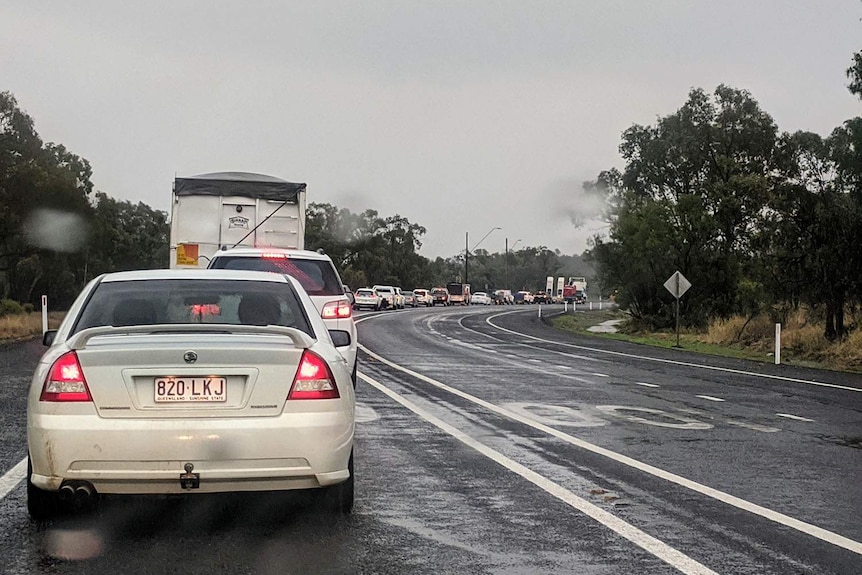 Motorists queue in the rain at Queensland-NSW border crossing at Goondiwindi in southern Queensland.