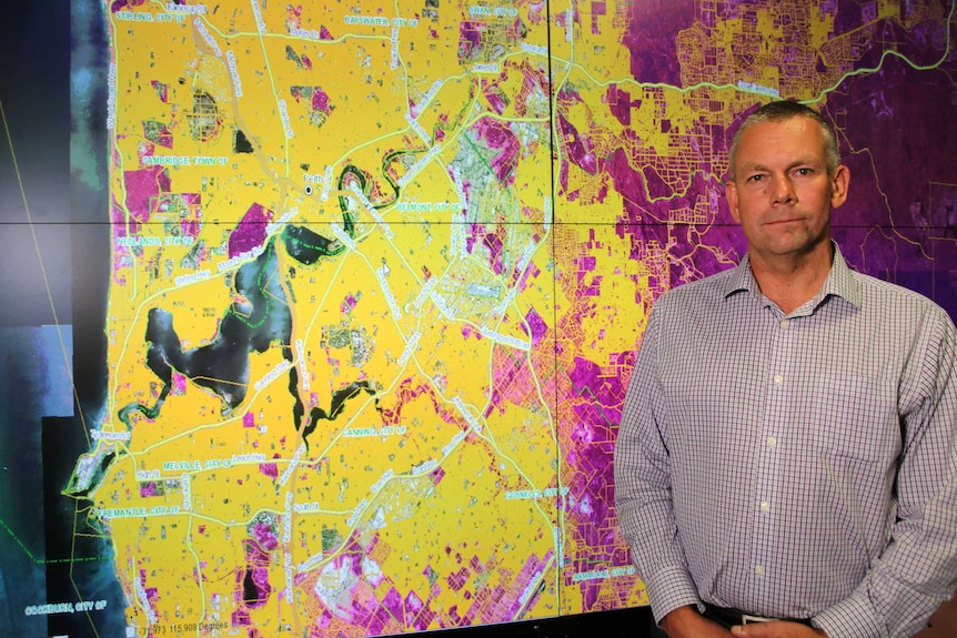 Office of Bushfire Management director Murray Carter in front of a fire map.