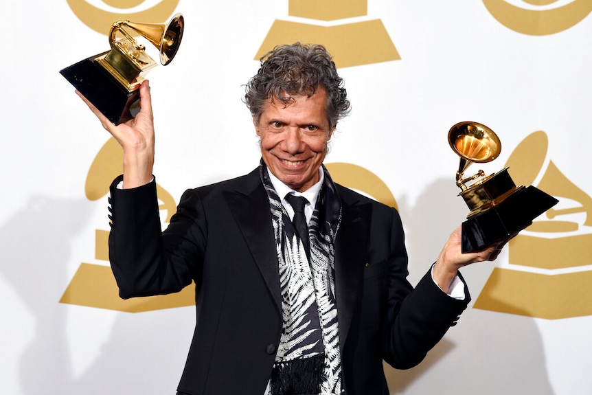 Chick Corea poses in the press room with the awards for best improvised jazz solo for "Fingerprints" and best jazz instrumental