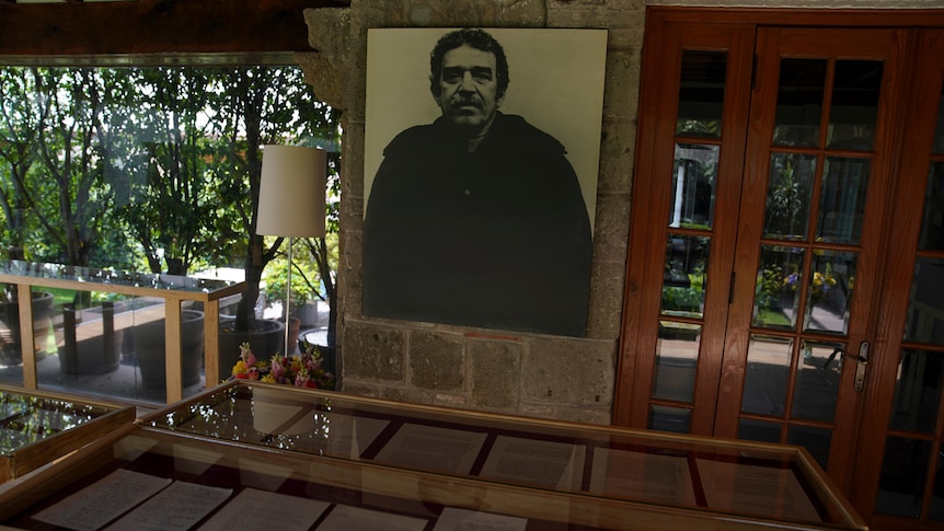 A picture of Gabriel García Márquez sits behind a glass display cabinet