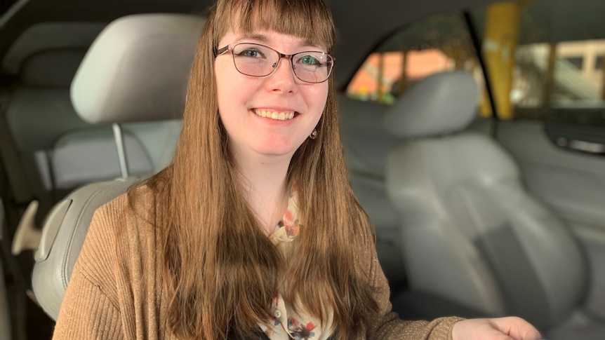 a woman in a car reading documents