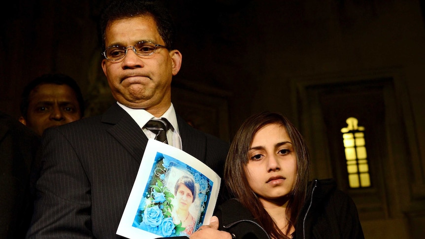 Ben Barboza stands with daughter Lisha as he holds a picture of wife Jacintha Saldanha.