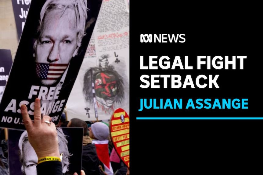 Legal Fight Setback, Julian Assange: Placards advocating for Julian Assange's freedom are held up at a rally.