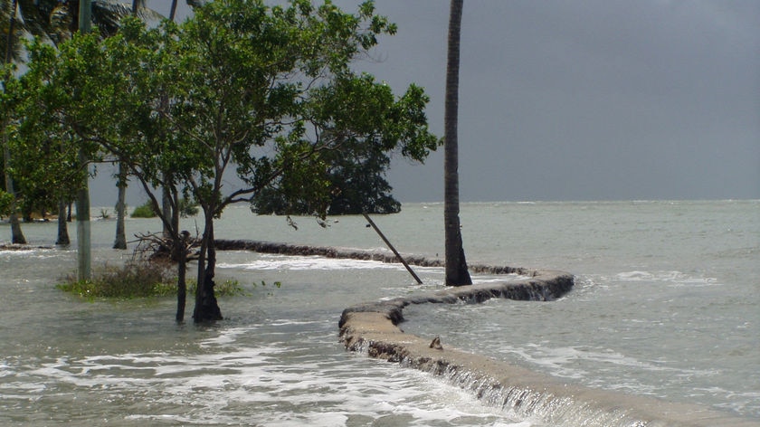 A king tide breaches a sea wall on Saibai Island.