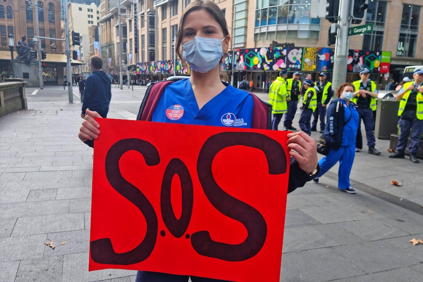 A nurse holding an sos sign