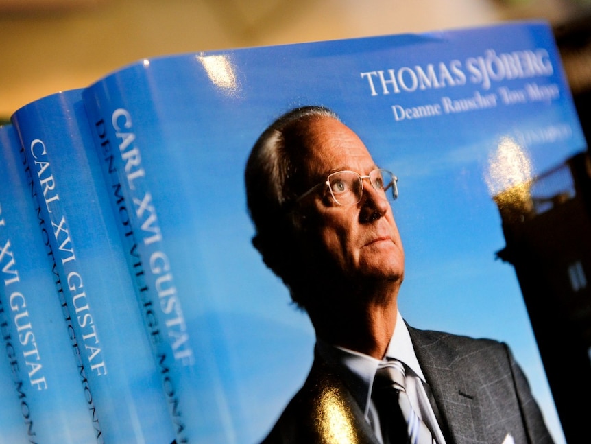 a stack of books, with a picture of a man looking on, on the cover