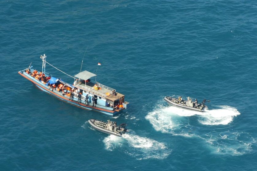 Aerial shot of customs ship escorting a boat of asylum seekers