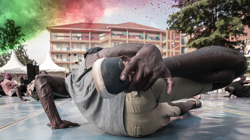 A photograph from ground level of a hip hop dancer on the ground.